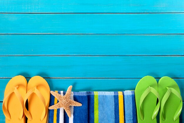 Free photo pair of flip flops over a wooden floor