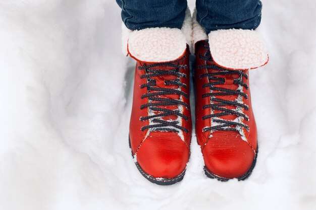 Pair of red boots on the snow