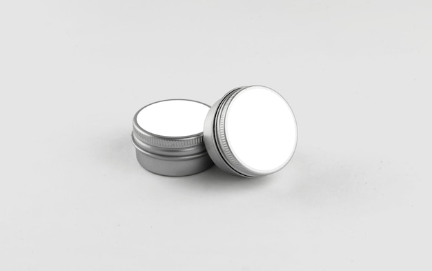 Free photo pair of round metal cosmetic tins with white label
