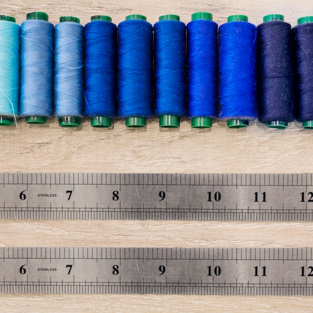 Free photo pair of scale near threads arranged in a row