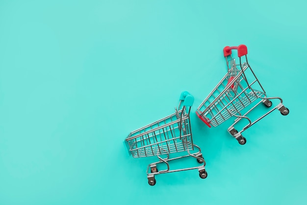 Free photo pair of shopping cart miniatures