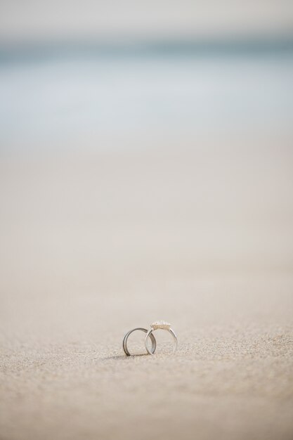 Pair of wedding ring on sand