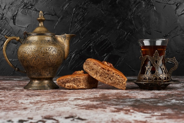 Pakhlava and tea on the marble.