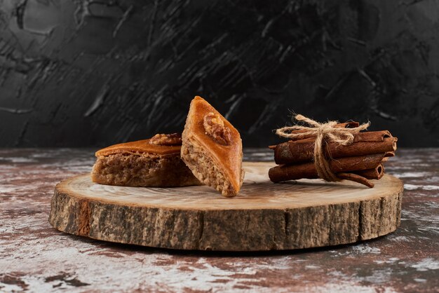 Pakhlava with cinnamon on a wooden board.