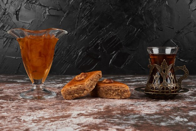 Pakhlava with drink on a wooden board.