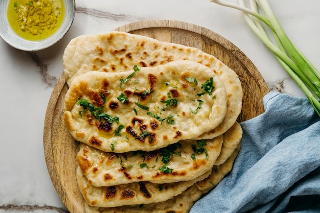 Pakistani food on wooden board top view