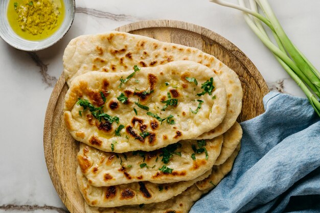 Pakistani food on wooden board top view