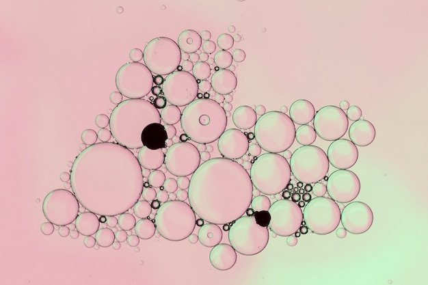 Free photo pale pink abstract bubbles with black dots