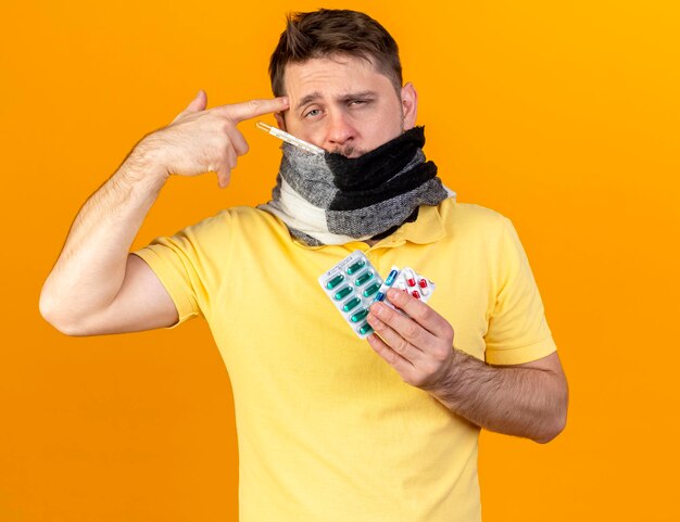 Pale young blonde ill slavic man covering mouth with scarf