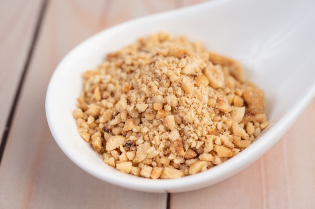 Palm sugar chopped in a cup on the wooden floor.