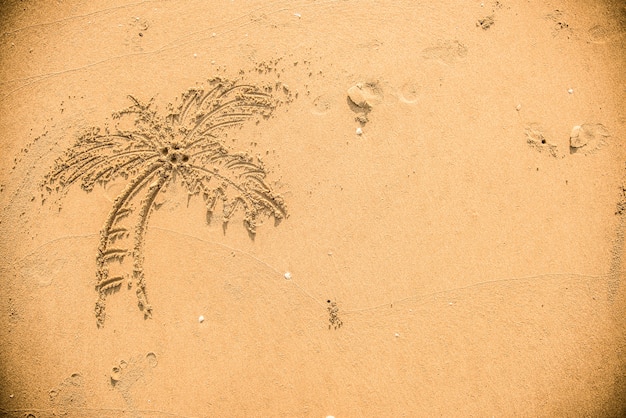 Free photo palm tree drawn in the sand