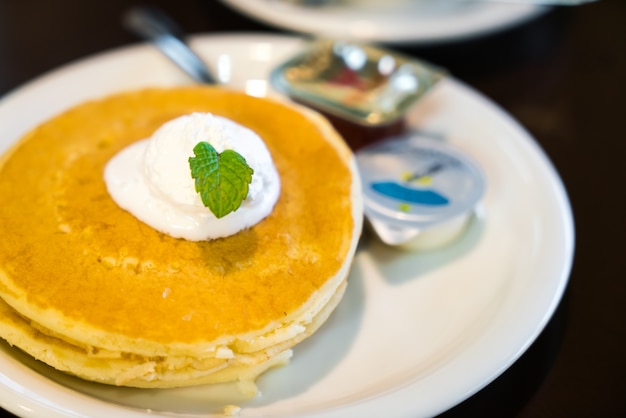 Pan cake with ice cream on table