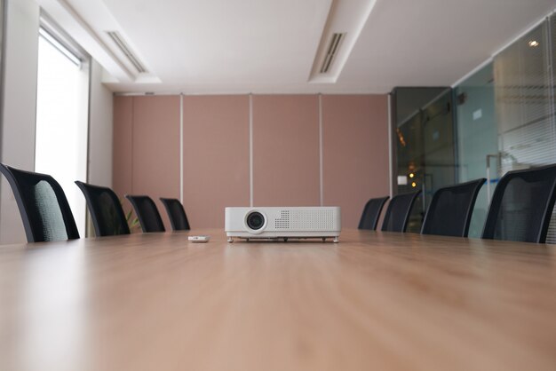 Pan shot of an empty office with the projector in the middle of a conference desk