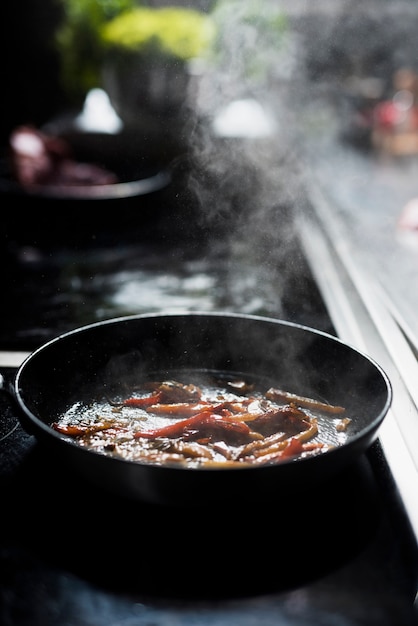 Free photo pan with fried vegetables on stove