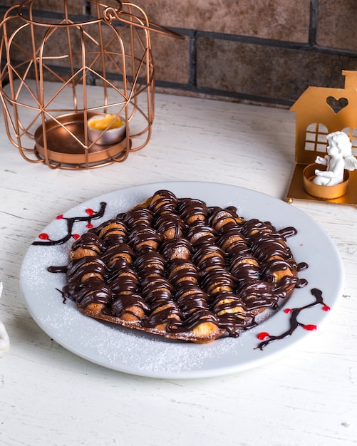 Free photo pancake under chocolate on the table