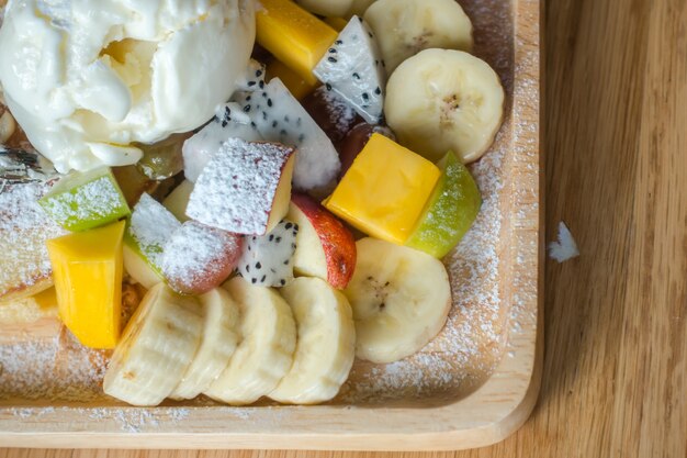 Pancake and fruit with ice cream on table .