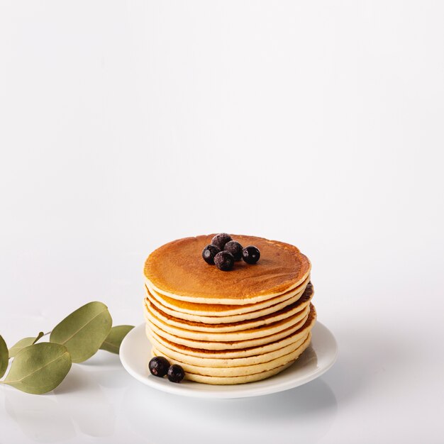 Pancake tower on plate with blueberries