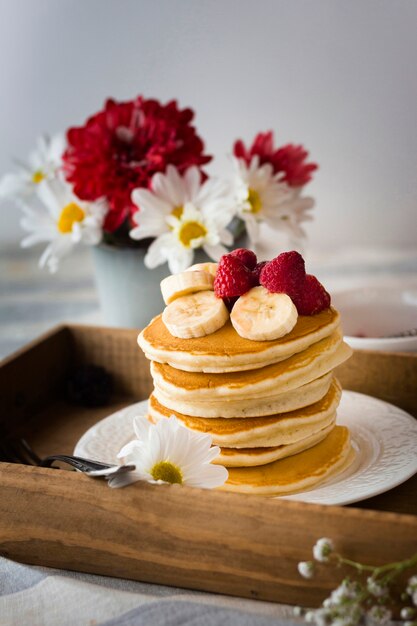 Pancake tower with banana and raspberries