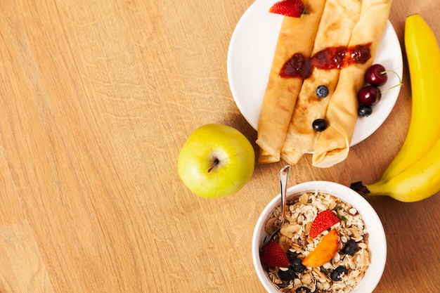 Pancakes and cereal with fruits