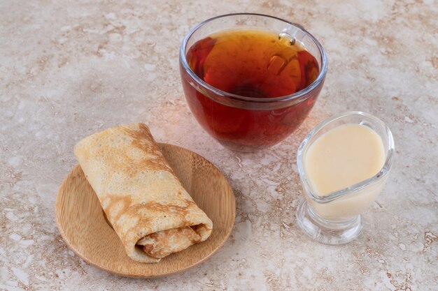 Pancakes with condensed milk and a cup of tea