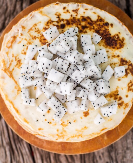 Pancakes with Dragon fruit on a wooden board