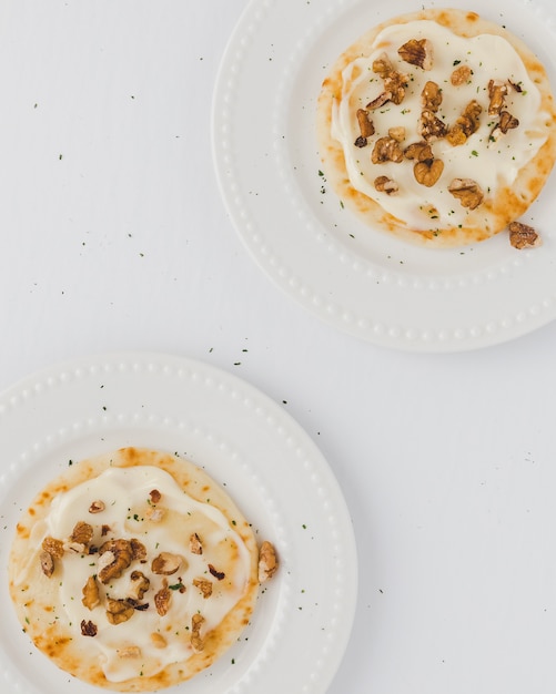 Pancakes with melted cheese and nuts, top view