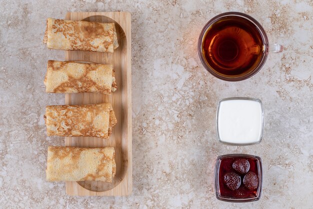 Pancakes with sour cream and a cup of tea