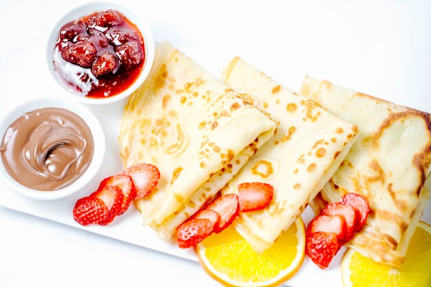 Pancakes with strawberries jam and chocolate cream