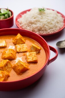 Paneer butter masala or cheese cottage curry served with rice and laccha paratha