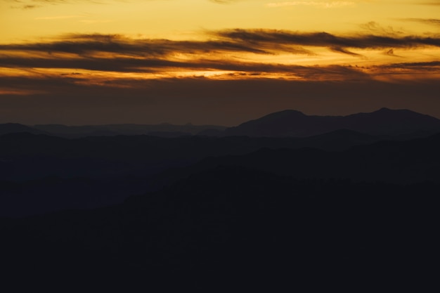 Panoramic mountain and dramatic sky sundown background in golden