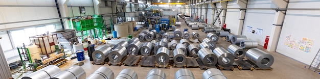 Panoramic photo of production line of metal tile for roof Steel forming machine in metalwork factory workshop Metal sheet profiling machine Background of plant