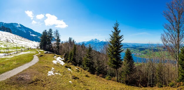 Panoramic shot of the beautiful mountains under the blue sky in Switzerland