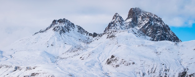 Panoramic shot of beautiful rocky mountains covered with snow in France