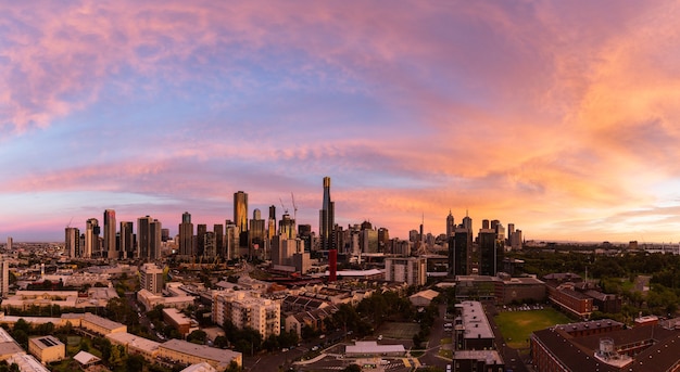 Panoramic shot of a cityscape under the beautiful orange sky during sunset