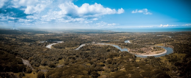 Panoramic shot of a curvy river in the middle of trees in Papua New Guinea