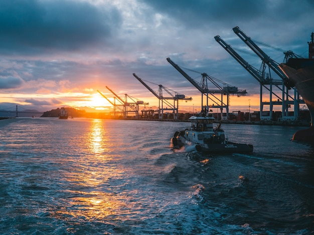 Panoramic shot of oil rigs at sea with a beautiful sunset