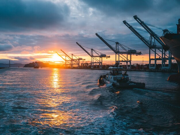 Panoramic shot of oil rigs at sea with a beautiful sunset