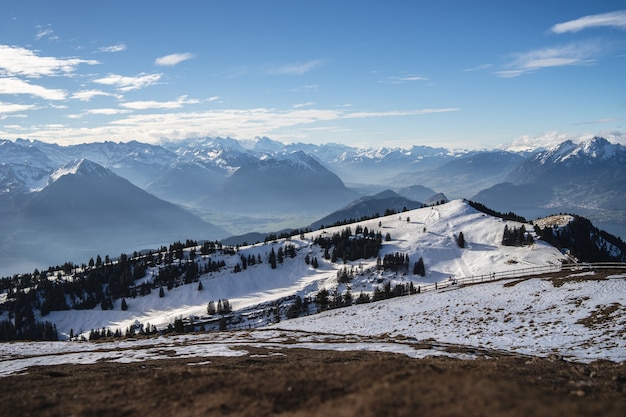 Panoramic shot of the Rigi Mountains in Arth Switzerland, under a blue sky during winter