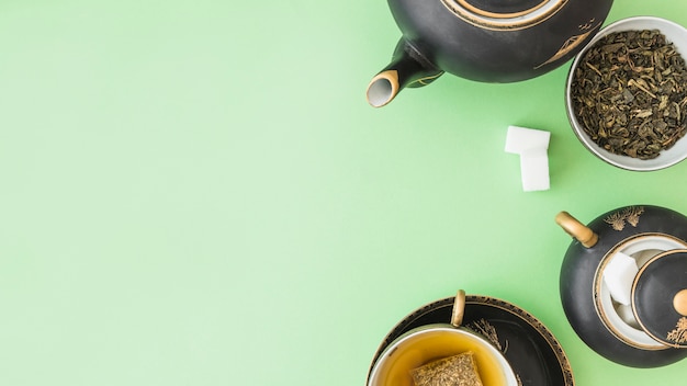 Panoramic view of herbal tea set with two sugar cubes on pastel background