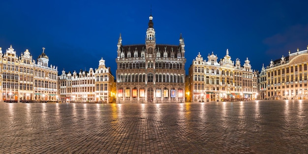 Panoramic view of majestic grand place square with kings house or breadhouse at night in brussels be...