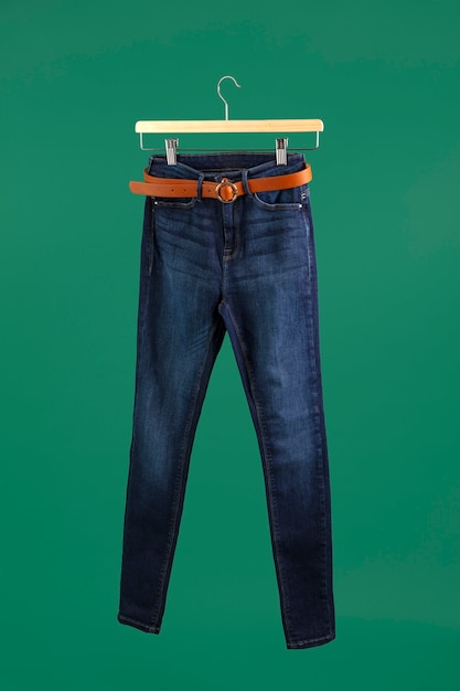 Pants on hanger with green background