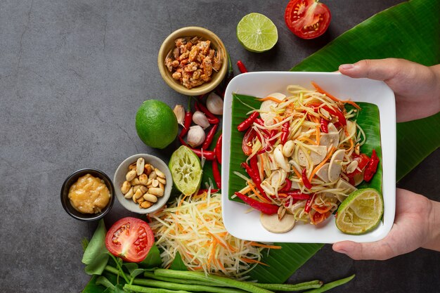 Papaya salad served with rice noodles and vegetable salad Decorated with Thai food ingredients.