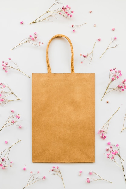 Free photo paper bag among tender flowers