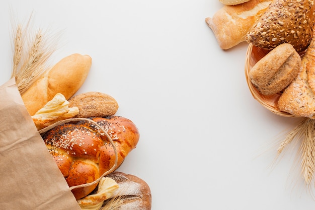 Paper bag with bread and basket of pastry