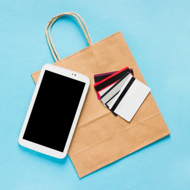 Paper bag with smartphone and credit cards