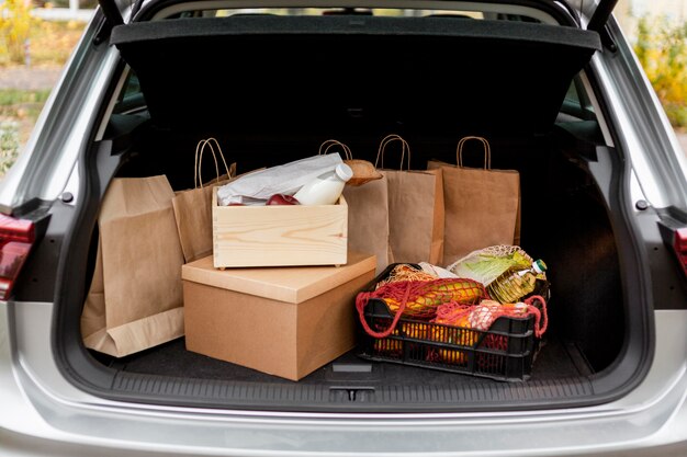 Paper bags and crates in car's trunk