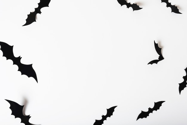 Free photo paper bats hanging on white wall