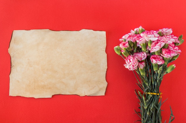 Paper and bouquet of fresh wonderful flowers