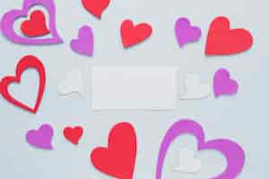 Free photo paper card amidst hearts