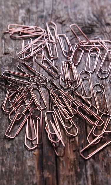 Paper clip on a dark wood background